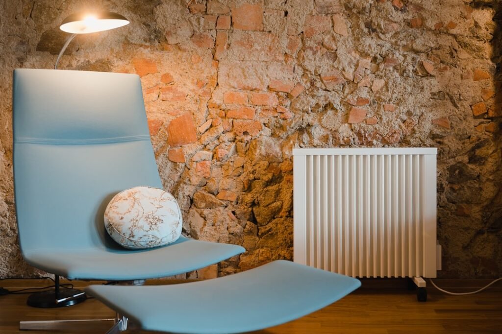 Electric heater beside an armchair in a warm living room